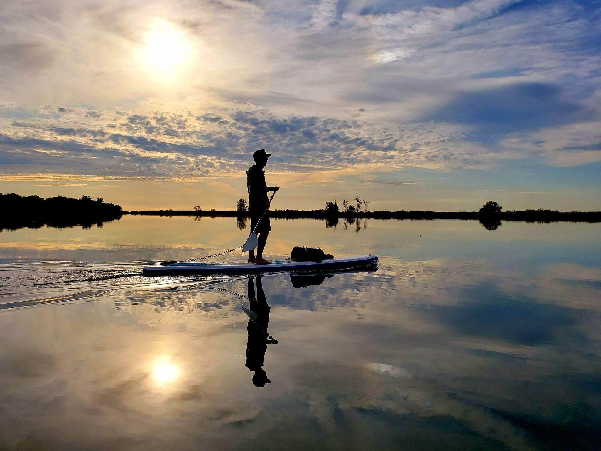 Man paddleboarding calm waters